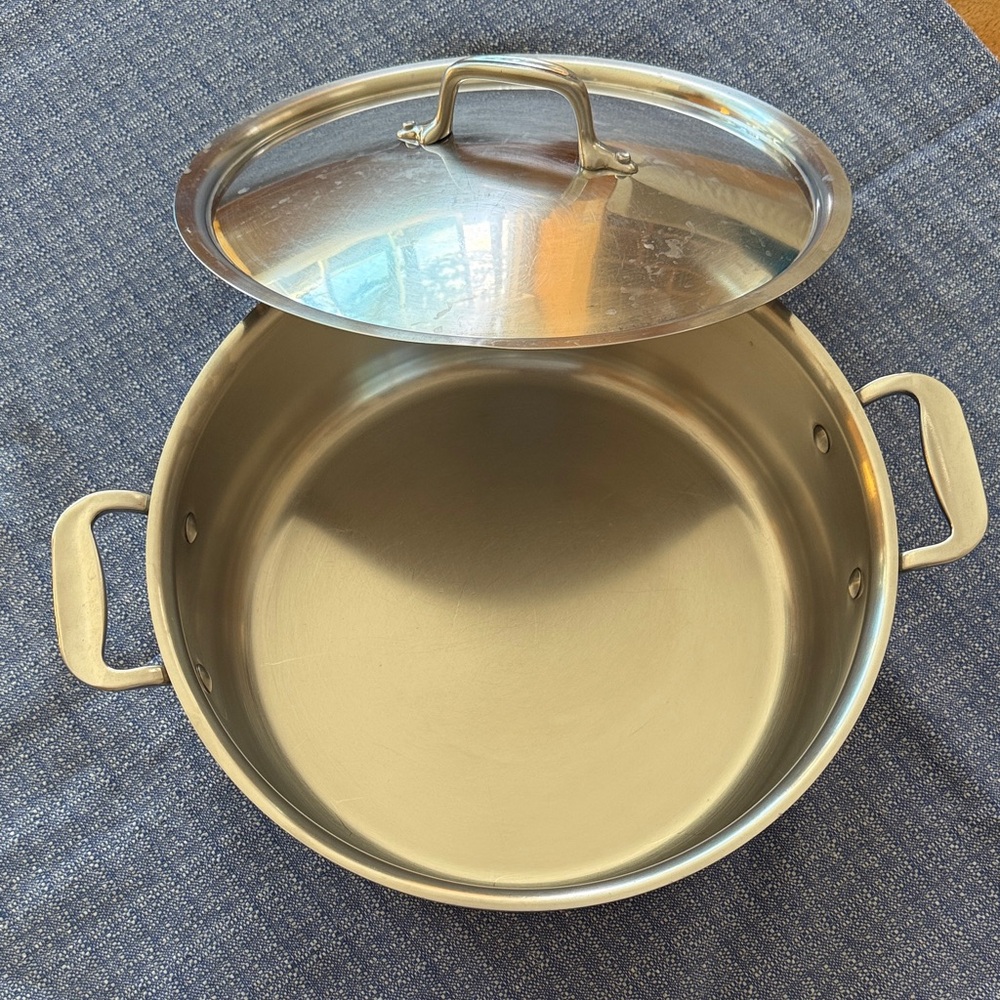 All-Clad 6-quart Stainless Steel Stock Pot with Lid and original storage bag.